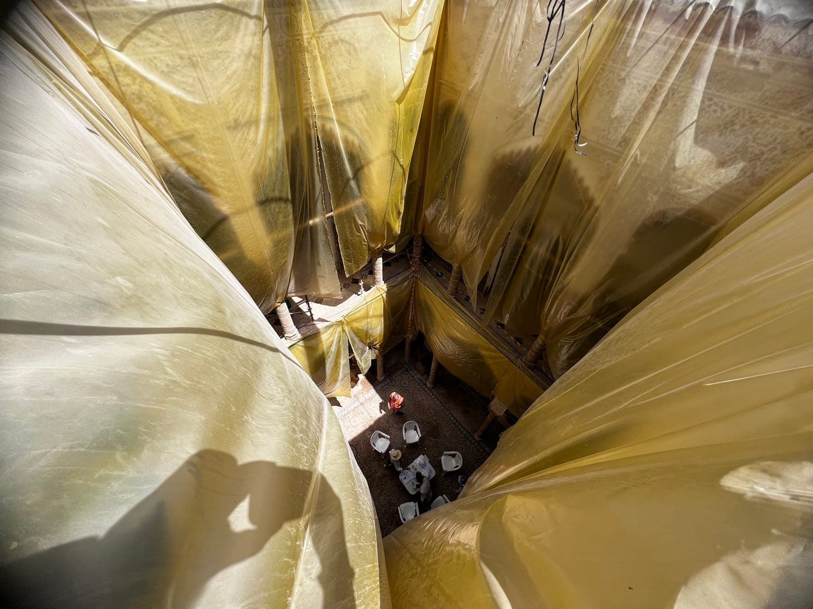 Protective sheeting stretched over the courtyard